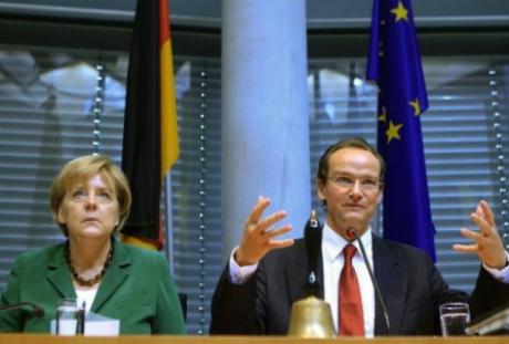 German Chancellor Angela Merkel attends a session of the EU committee of the German lower house of parliament, the Bundestag, headed by Gunther Krichbaum (R) in Berlin, September 29, 2010. REUTERS/Thomas Peter